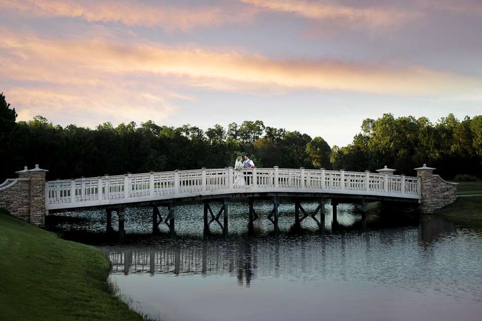 bride and groom on the bridge at the St Johns Golf and Country Club