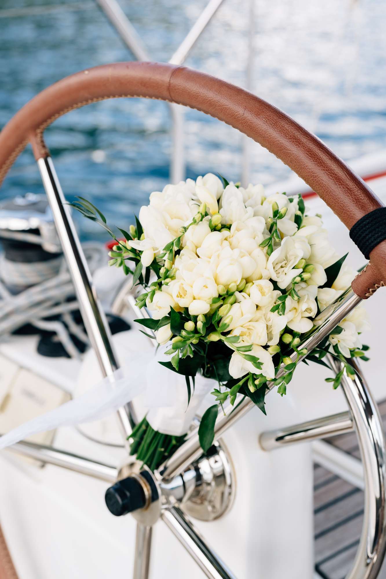bridal bouquet on a sailboat steering wheel