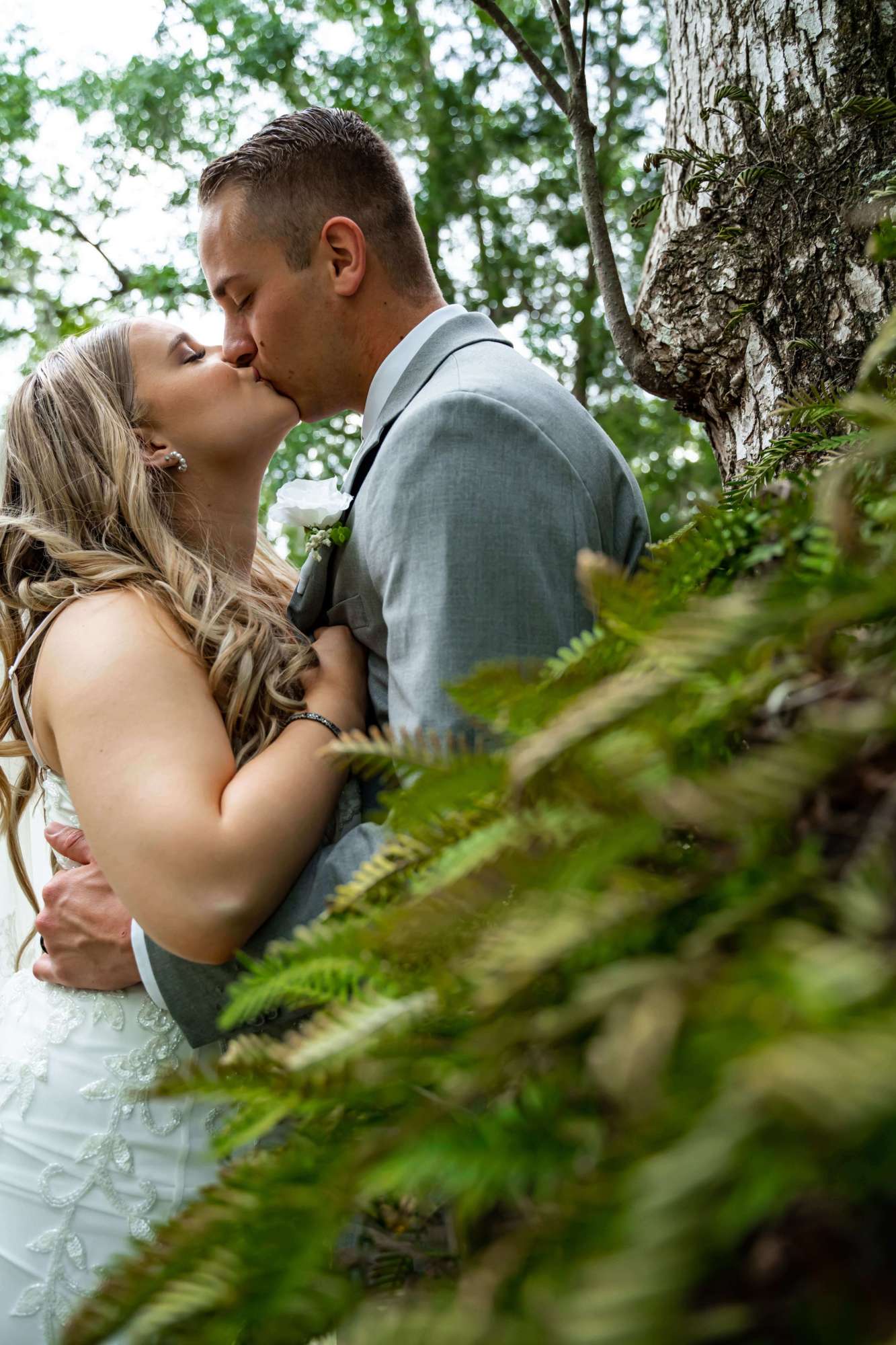 bride and groom kissing against a tree. Breathless Imagery and Premier Bride of Jacksonville