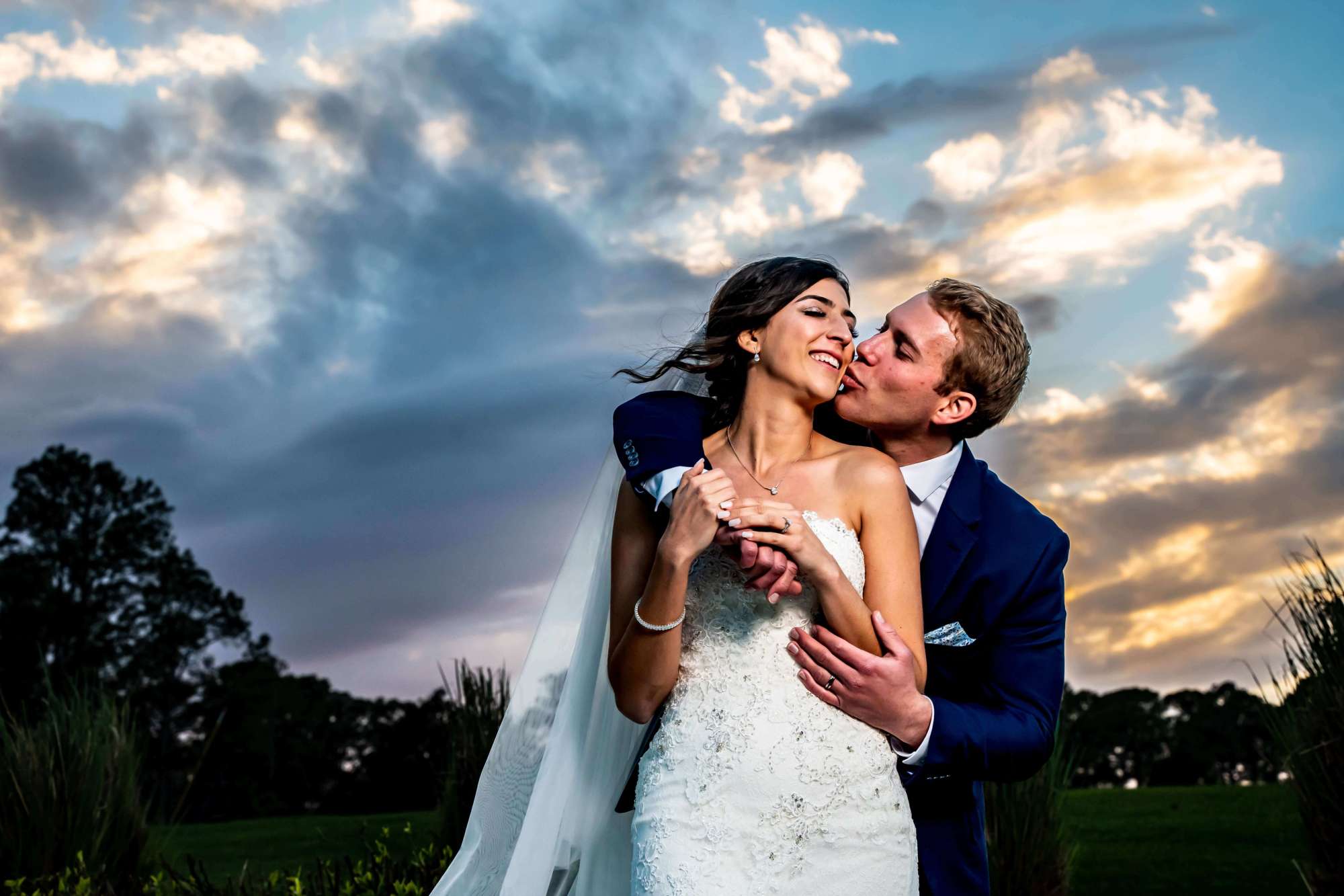 Bride and groom with pretty clouds at sunset. Breathless Imagery and Premier Bride