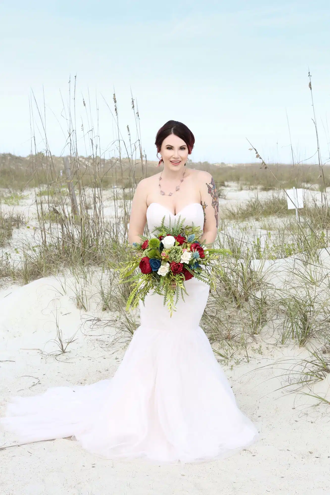beach bride holding a bouquet in the dunes becphotography premier bride beach bride holding a bouquet in the dunes becphotography premier bride