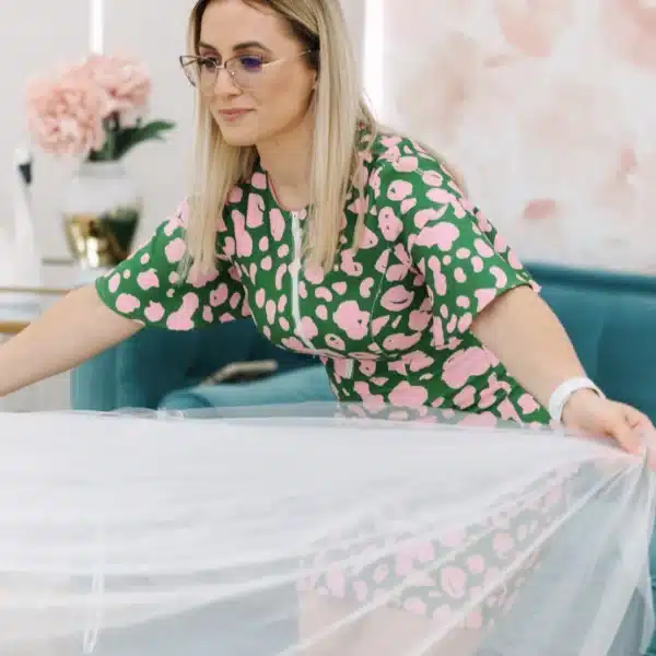Be That Queen Bridal helping a bride try on a wedding gown
